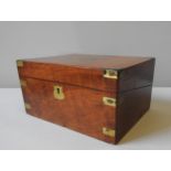 A VICTORIAN WALNUT BRASS BOUND WRITING SLOPE, the lid opening to reveal fitted interior with a