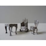 THREE PIECES OF MINIATURE SILVER DOLL'S FURNITURE, comprising of an ornate repousse decorated