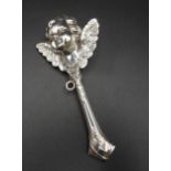 A SILVER BABY'S RATTLE, in the form of a winged cherub, stamped 925, 12 cm long, 23 grams