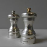 A SILVER ENCASED 'PETER PIPER' PEPPER MILL AND MATCHING SALT MILL, by Park Green, circa 1982, both