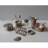 A SILVER CREAM JUG, TOAST RACK, AND A SILVER FEEDING BOWL WITH SPOON, along with a silver conch