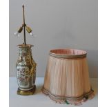 A CHINESE CANTON FAMILLE ROSE VASE, converted to a table lamp, with shade, the panels profusely