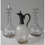 AN ORNATE 19TH CENTURY CLARET JUG, TWO DECANTERS AND GLASS CANDLESTICK, the claret jug etched with