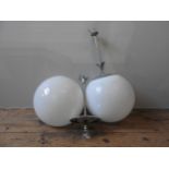 A PAIR OF RETRO PENDANT LIGHT FITTINGS, chromed metal fixtures with large globular white glass