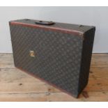 A VINTAGE LOUIS VUITTON SUITCASE, with LV monogram covering and leather handle with stamped L.