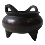 A CHINESE BRONZE TRIPOD CENSER, of compressed globular form,  with twin handles, the base