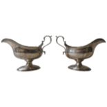 A PAIR OF GEORGE III SILVER SAUCE BOATS ON PEDESTAL BASE, by William Skeen, London, circa 1780, with