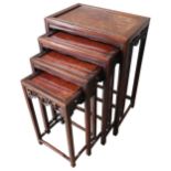 A NEST OF FOUR CHINESE STYLE SIDE TABLES, burr walnut top panels inset in a hardwood frame, the