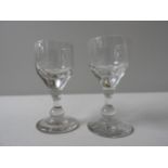 A SET OF TWELVE LATE 18TH CENTURY BALUSTROID CORDIAL GLASSES, 11 cm high, along with multi faceted