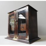 A VINTAGE OAK PIPE SMOKER'S CABINET, the fitted interior enclosed by two glazed doors, with brass