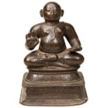 A SMALL INDIAN BRONZE FIGURE OF KRISHNA 15TH/16TH CENTURY depicted in the lotus position upon a