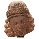 AN INDIAN SANDSTONE HEAD OF A BODHISTATTVA NORTHERN INDIAN, 11TH/13TH CENTURY, the fine ringleted