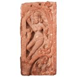 A MOTTLED SANDSTONE RELIEF PANEL OF A DANCING DEITY, INDIA, PROBABLY UTTAR PRADESH, 10TH /11TH