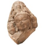 A CARVED SCHIST FRAGMENTARY HEAD OF SHIVA  CIRCA 10TH/11TH CENTURY flanked by two Disciples probably