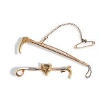 A LATE VICTORIAN GOLD RIDING CROP BROOCH, CIRCA 1890 realistically modelled   Stamped 9ct 6.3cm long