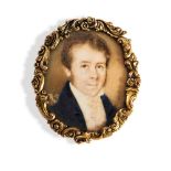 A GILT METAL MOUNTED OVAL PORTRAIT MINIATURE depicting a gentleman in blue coat. Painted on mother