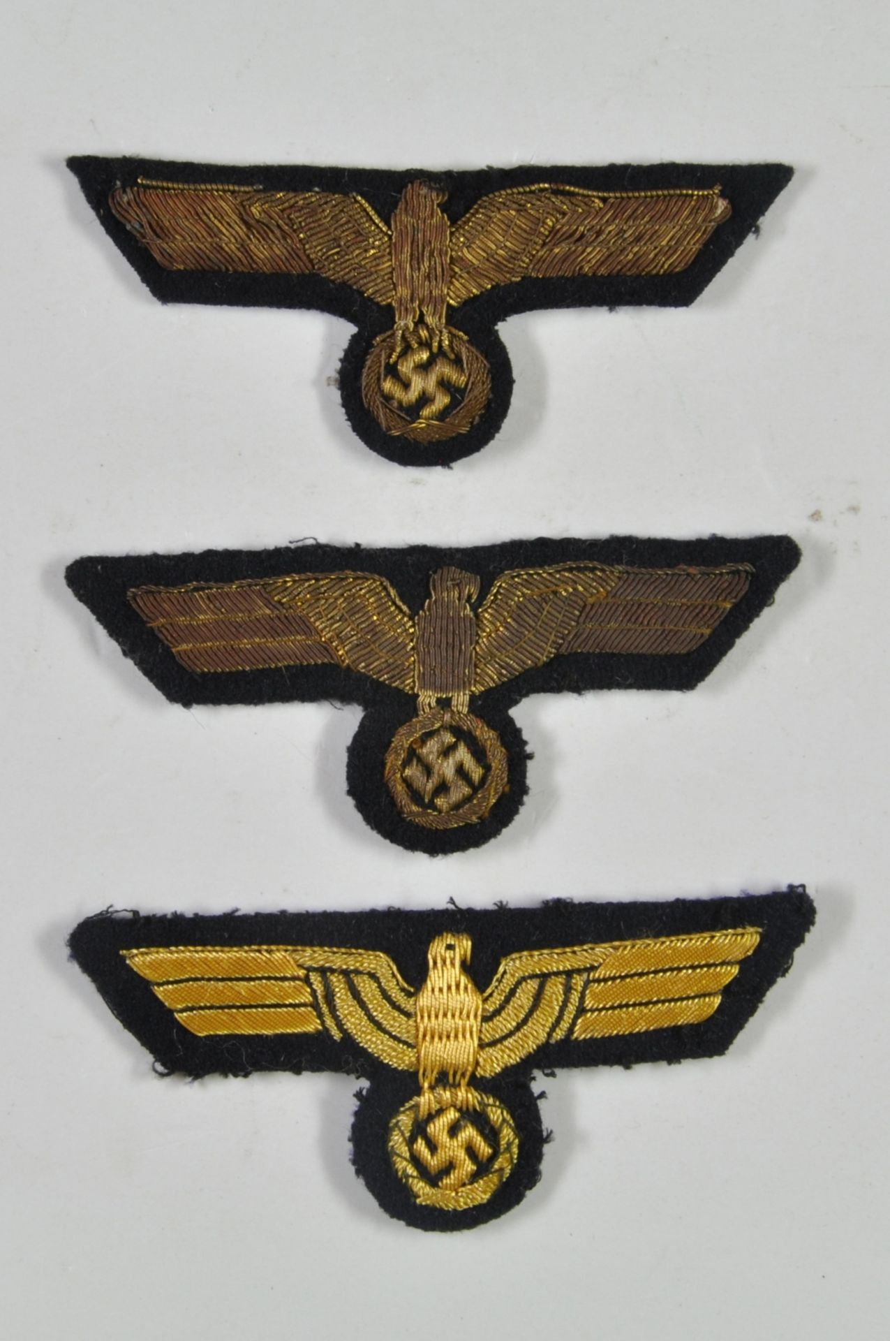 3 x breast eagle for officers, on dark blue fabric, 2 x on the reverse side with paper cover,