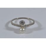 Antique diamond (.33ct) & pearl ring with channel set diamond shoulders on white metal which tests p