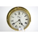 Brass cased ships clock with key, F. Smith & Son Southampton. Diameter of face 18cm.