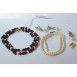 Two 9ct gold clasped necklaces, including pearl (stones deficient from clasp) & a pearl with red bea
