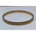 9ct gold bangle, with engine turned decoration, inner diameter 72mm, 9.89 grams