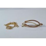 9ct gold wishbone brooch & a 9ct gold bracelet with horseshoe clasp, gross weight 5.1 grams