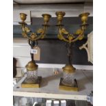 Pair of Empire style gilt metal, patinated bronze & glass two branch candelabras, the support modell