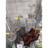 Two cut glass ice buckets, cut glass decanter with plated collar, two ice tongs & a novelty carved w