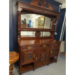 Impressive mirror back chiffonier with carved lions and wing cherub busts, dated 1902 comprising of