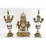 C20 reproduction of a C19 French style gilt brass mantle clock with garniture. Likely produced by Fa
