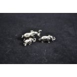 Silver set of three miniature graduated elephants, maker MH, Sheffield 2001, largest 4.2cm wide, gro