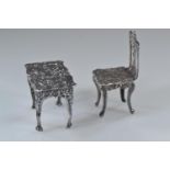 Miniature silver table & chair, maker Richards & Knight, London 1970 & 1978 respectively, decorated