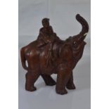 Wooden carved figure of an elephant and rider, impression on base of elephant's foot H16cm