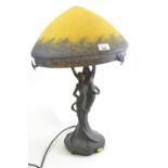 Figurative lamp base of young couple with a Tiffany style shade, height 58cm