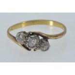 Yellow metal & three stone diamond ring, marks rubbed but tests positive for 18ct gold, size O, 1.97