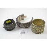 Three cuff bracelets, including white metal, gilt metal & another spiked metal
