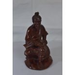 Wooden carved figure of an oriental man smoking a pipe H16cm