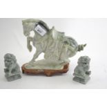 Carved green stone oriental horse and pair of Fo dogs, height of horse 22cm