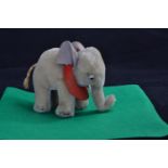 Vintage Steiff mohair elephant with tusks, felt ears and red felt saddle cloth, Steiff button to ear