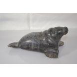 Canadian Eskimo Art Inuit carving of a walrus length 15cm x height 6.5cm, signed AC to base