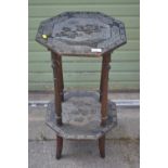 Octagonal two tier table with carvings of bird and flowers