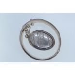 Silver HM hinged bracelet & a white metal locket, both with a personal inscription,