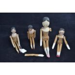 Four C19th Dutch type wooden peg dolls, with jointed limbs and painted faces, largest doll 26.5cm he