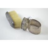 Two HM silver napkin rings, gross weight 42.8 grams, & a sterling silver mounted clothes brush (wear
