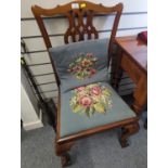 Mahogany framed chair with needle work Upholstery and claw feet.