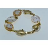 18ct gold & mother-of-pearl bracelet, each shell panel with a gold or shell heart motif, circumferen