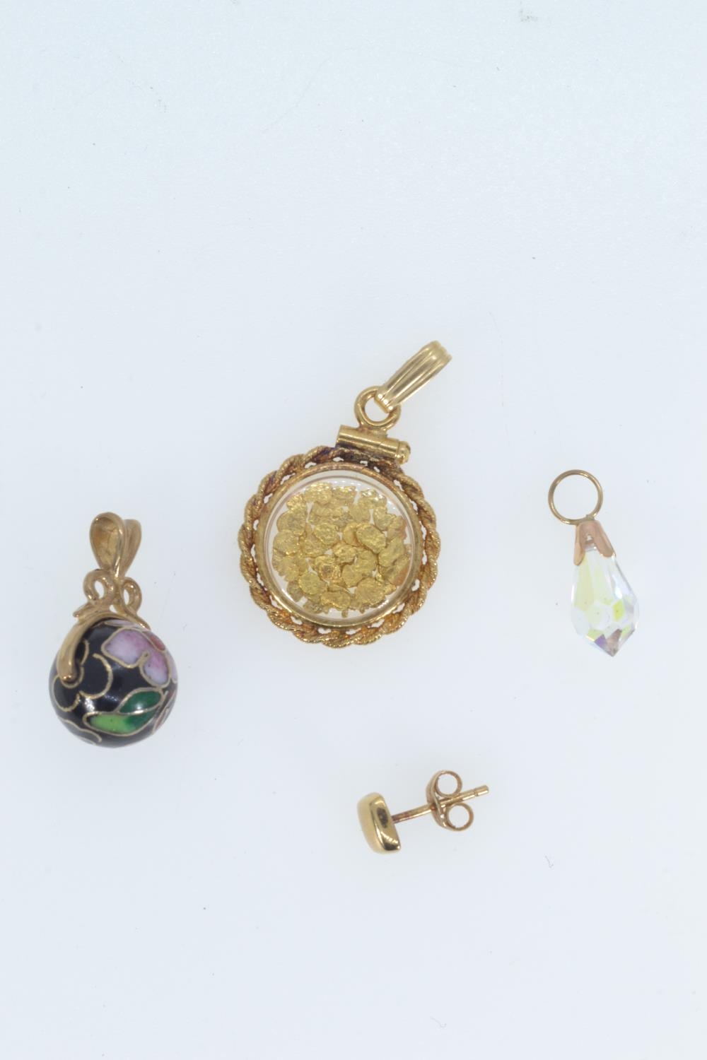 Three pendants, including: a 12ct gold dust pendant; yellow metal & cloisonné pendant & a yellow met