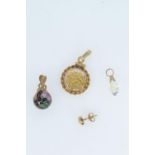Three pendants, including: a 12ct gold dust pendant; yellow metal & cloisonné pendant & a yellow met