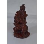 Wooden carved figure of an oriental man smoking a pipe H16cm