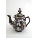 Large Measham barge ware treacle glazed teapot, late 19th century, bearing the motto 'Home Sweet Hom